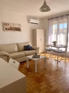 拉加爾德的住宿－La Garde : joli studio dans résidence，客厅配有沙发和桌子