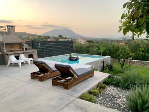 a patio with two chairs and a swimming pool at The Backyard in Éva