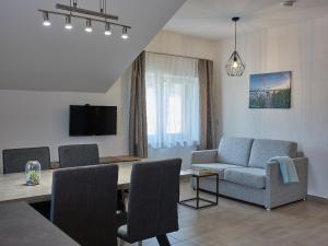 a living room with a table and chairs and a couch at Mayr-Hof (Mank) Appartement in Seimetzbach