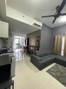 a living room with a couch and a ceiling fan at Kyra Homestay Centrus SOHO Cyberjaya *wifi and pool* in Cyberjaya