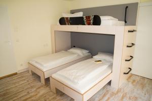 a bunk bed with two beds in a room at Oberstdorf Hostel in Oberstdorf