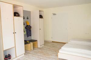a bedroom with white cabinets and a bed in it at Oberstdorf Hostel in Oberstdorf
