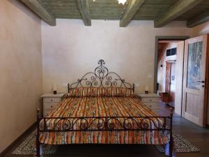 a bedroom with a bed with an ornate headboard at AL CASALE SANT' ANNA PELAGO in SantʼAnna Pelago