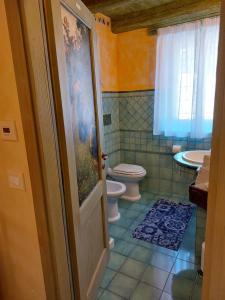 a bathroom with a toilet and a sink at AL CASALE SANT' ANNA PELAGO in SantʼAnna Pelago