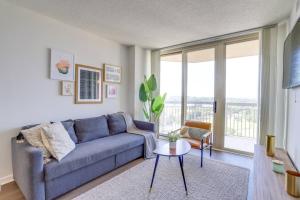 a living room with a blue couch and a table at Exclusive Apt in Ballston with Gym in Arlington