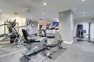 a gym with treadmills and elliptical machines at Exclusive Apt in Ballston with Gym in Arlington +19 photos