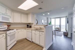 a kitchen with white cabinets and a large window at Amazing 1 Bedroom Condo At Ballston With Gym in Arlington