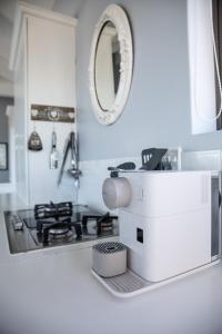 a white kitchen counter with a sink and a microscope at The Loft in Wilderness