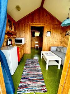 a kitchen and a living room with a couch and a table at Base Camp Hamarøy in Sørkil