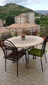 un tavolo e sedie seduti su un patio di IL MULINO Appartamento Itri centro 150 m2 con ampio terrazzo completo di tutti i comfort a Itri