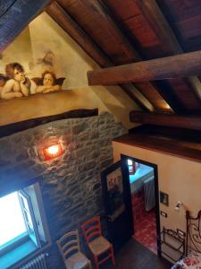 an attic room with a painting of two dolls on the wall at AL CASALE SANT' ANNA PELAGO in SantʼAnna Pelago