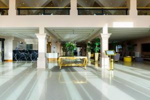 a lobby with a gold bench in the middle of a building at Lagos Del Calafate in El Calafate +127 photos