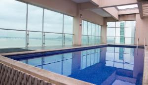 a swimming pool with a view of the water at Suite 206, Riverfront, vista al río, Puerto Santa Ana, Guayaquil in Guayaquil +4 photos