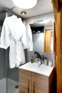 a bathroom with a sink and a mirror at Observatory at South Downs Stay in Houghton