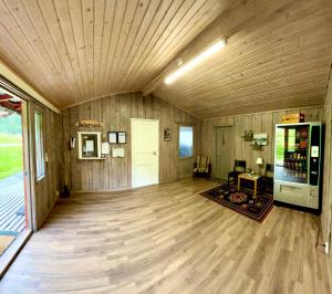 a large room with wooden floors and a wooden ceiling at Base Camp Hamarøy in Sørkil