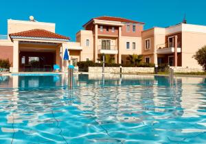 a swimming pool in front of a building at Golden Victory in Agia Marina Nea Kydonias