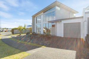 a large house with a garage in front of it at Lake Taupo Gem in Taupo