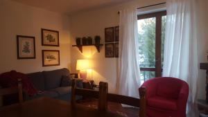 a living room with a couch and a table and a window at coeur de neige in Claviere