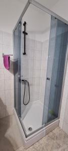 a shower with a glass door with a cross at SmartStar in Split +13 photos