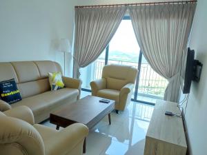 a living room with a couch and chairs and a tv at Link 2 Residence Bukit Jalil I HomeBrickz in Kuala Lumpur