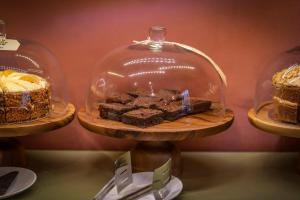 three cakes in a glass dome on a table at Spread Eagle Inn in Stourton