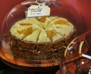 una torta su un piatto di vetro su un tavolo di Spread Eagle Inn a Stourton Altre 58 foto