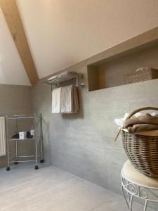 a bathroom with a towel rack and a basket on the wall at Alpin Apart Maurer in Längenfeld +38 photos