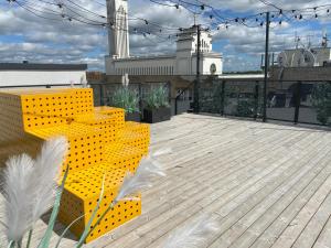 a yellow bench sitting on top of a roof at Radio city loft in Kaunas