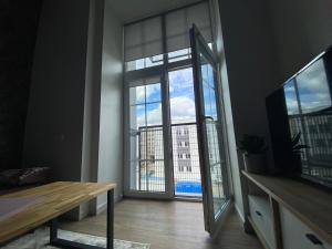 a room with a large window with a view of a building at Radio city loft in Kaunas