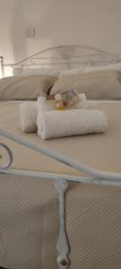 a bed with two towels on top of it at UltimoCasale in Matera