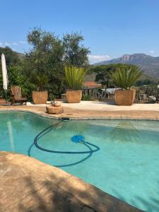 a swimming pool with a hose in the water at Ithaba Falls Guest Farm Farm L59, Buffelsvley, Burgersfort, 1150 in Boerboomskraal
