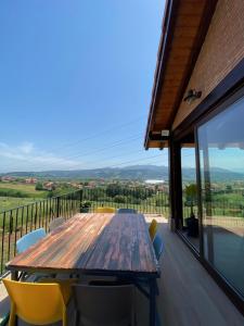 a wooden table and chairs on a deck with a view at Casa Los Rinocerontes in Penagos