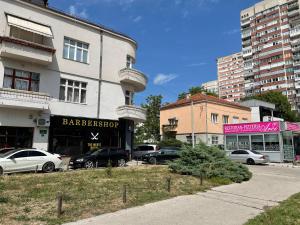 a parking lot with cars parked in front of a building at Amigi in Sarajevo