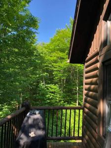 a balcony of a house with a tree at Quiet, cozy and comfortable chalet in Val-des-Lacs