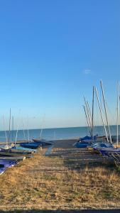 a row of boats are lined up on the beach at Bexhill Luxury Sea Stay Flat 2 in Bexhill