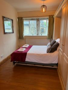 a bedroom with a large bed in a room at Cosy cottage with a canal view in Hebden Bridge