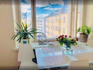 a room with a table and chairs and a window at Scandinavian Desing Home 37 City Center in Kamppi in Helsinki
