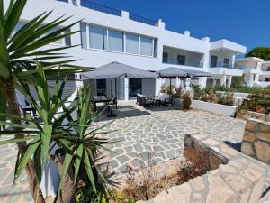 a villa with a patio in front of it at Courtyard Luxury Suites “ APOSTOLOS” in Pefki Rhodes