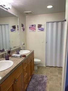 a bathroom with two sinks and a toilet and a shower at Resort Like Stay at a Cozy Relaxing Private Room Near UCI in Irvine