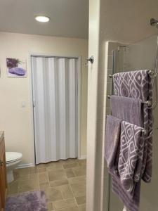 a bathroom with a toilet and towels on a rack at Resort Like Stay at a Cozy Relaxing Private Room Near UCI in Irvine