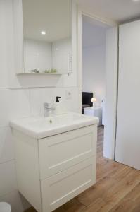 a white bathroom with a sink and a mirror at Unterkunft in Bergneustadt in Bergneustadt