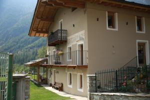 a large building with balconies and a bench in front at bnb Uja in Balme