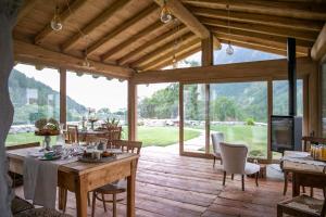 a dining room with a table and chairs on a wooden deck at bnb Uja in Balme