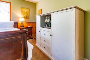 a bedroom with a large white cabinet next to a bed at J Patrick Inn in Cambria