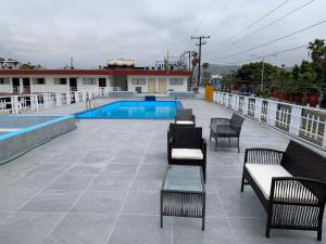 a patio with chairs and a swimming pool at Hotel Presidente in Ensenada