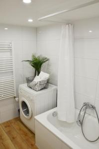 a white bathroom with a washing machine and a washer at Unterkunft in Bergneustadt in Bergneustadt