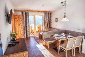 a living room with a table and a couch at Apart Sattelkopf in Fiss