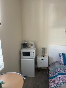 a small room with a table and a microwave at Resort Like Stay at a Cozy Relaxing Private Room Near UCI in Irvine