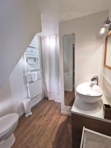 a white bathroom with a sink and a toilet at L'Ecrin des bords de l'Erdre - Les Maisons de Madeleine in Nantes