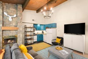 a living room with a couch and a fireplace at Aspenwood by Snowmass Vacations in Snowmass Village
